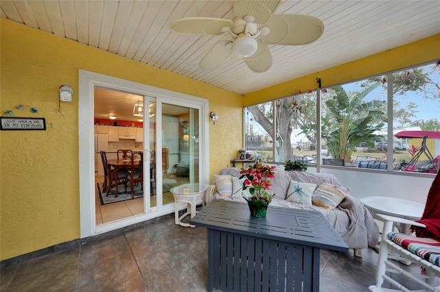 sunroom with ceiling fan and wooden ceiling