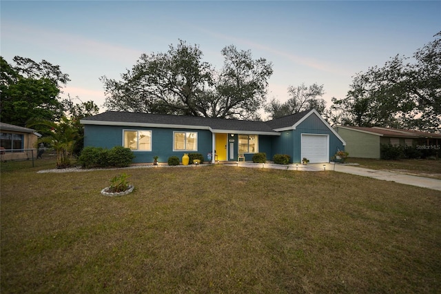 single story home with a yard and a garage