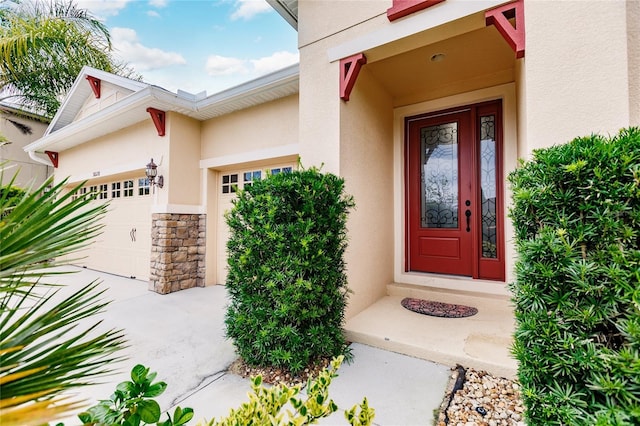 doorway to property with a garage