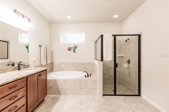 bathroom with tile patterned floors, vanity, and shower with separate bathtub