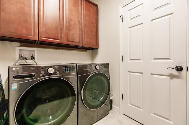 washroom featuring washer and dryer and cabinets