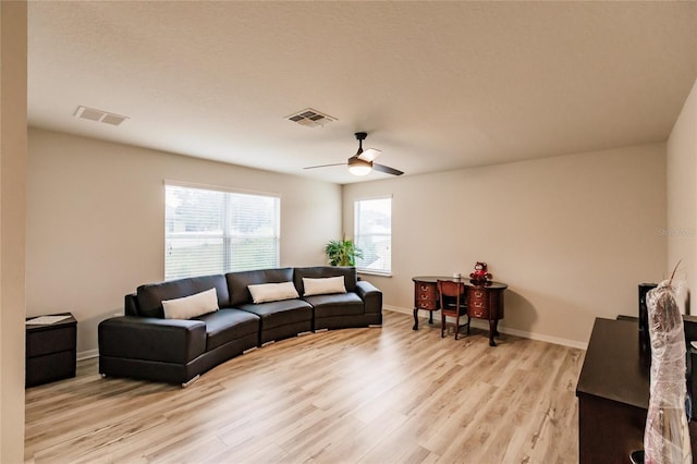 living room with ceiling fan and light hardwood / wood-style floors