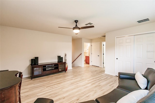 living room featuring ceiling fan and light wood-type flooring