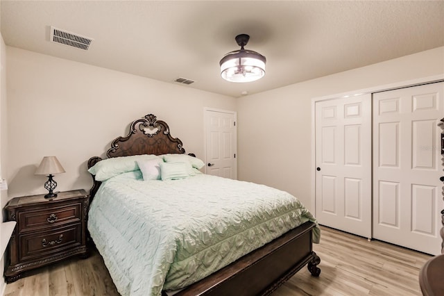 bedroom featuring a closet and light hardwood / wood-style flooring