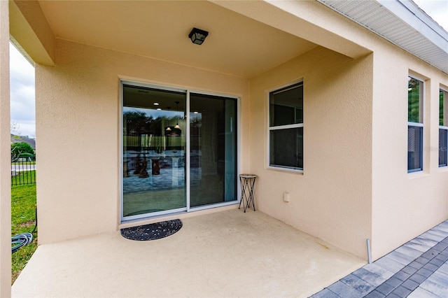 view of exterior entry featuring a patio