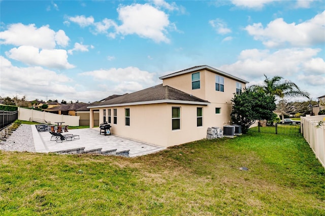 back of house with central air condition unit, a patio area, and a lawn