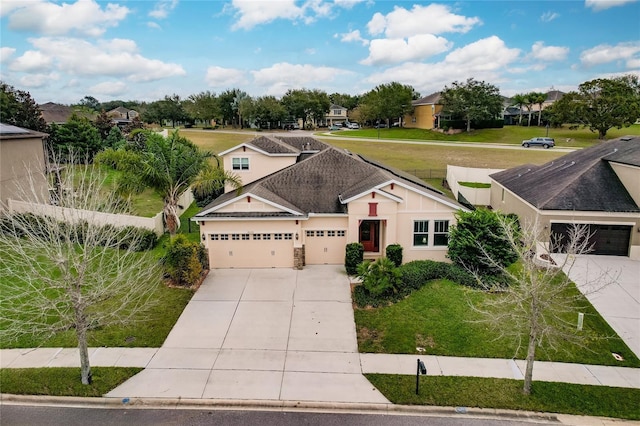 view of front facade with a garage and a front lawn