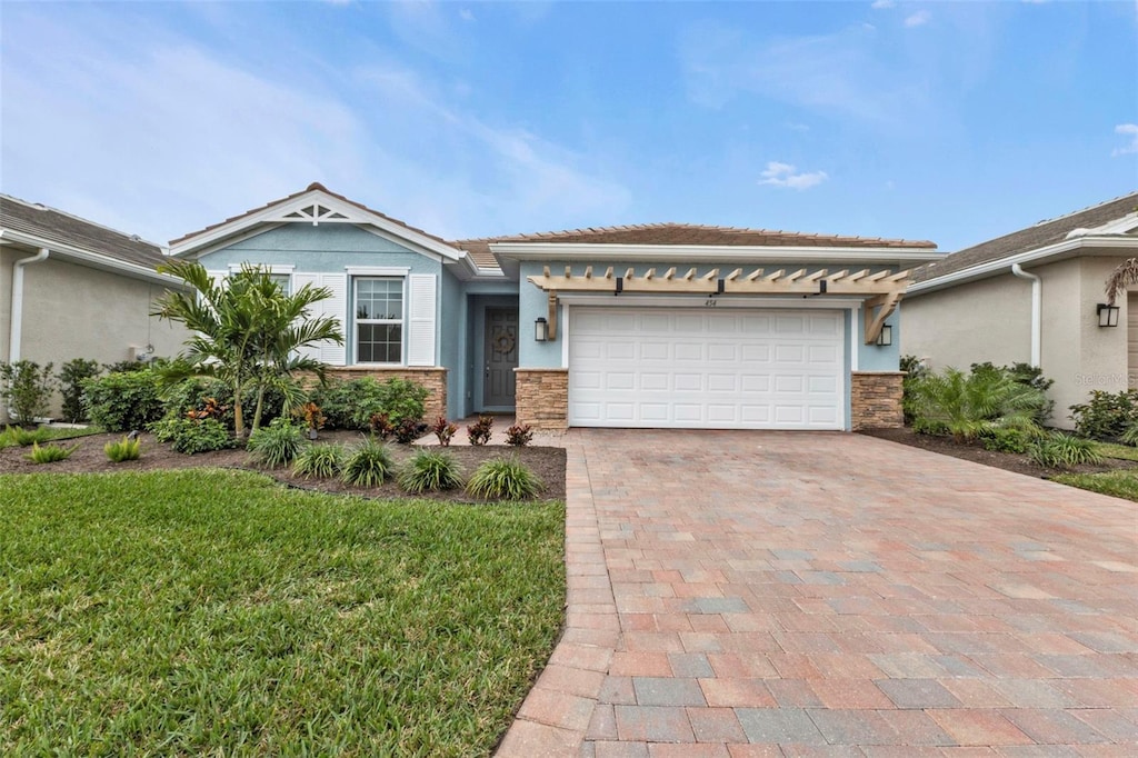 view of front of home with a front lawn and a garage