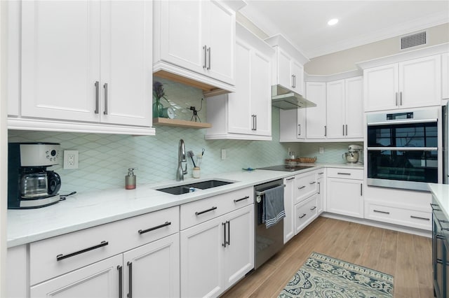 kitchen featuring white cabinetry, stainless steel appliances, crown molding, and sink