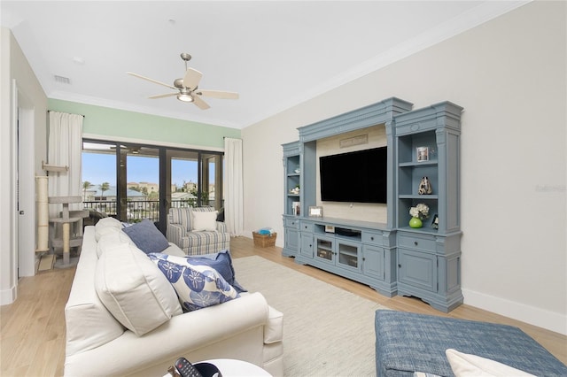 living room featuring crown molding, ceiling fan, and light hardwood / wood-style floors