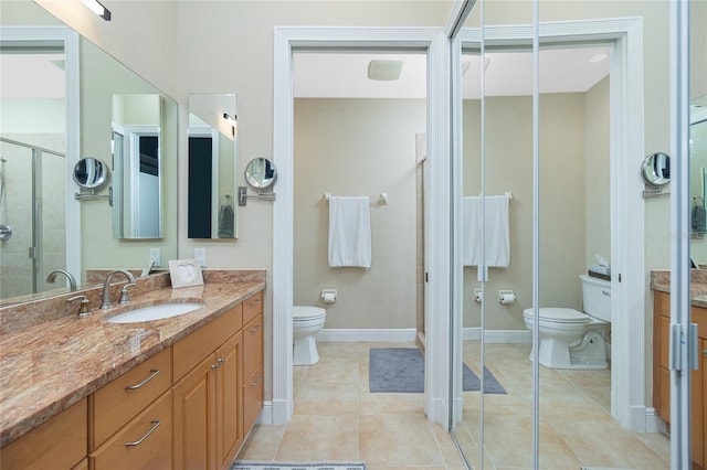 bathroom featuring tile patterned flooring, vanity, walk in shower, and toilet