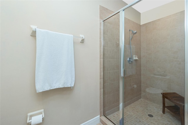 bathroom featuring walk in shower and toilet