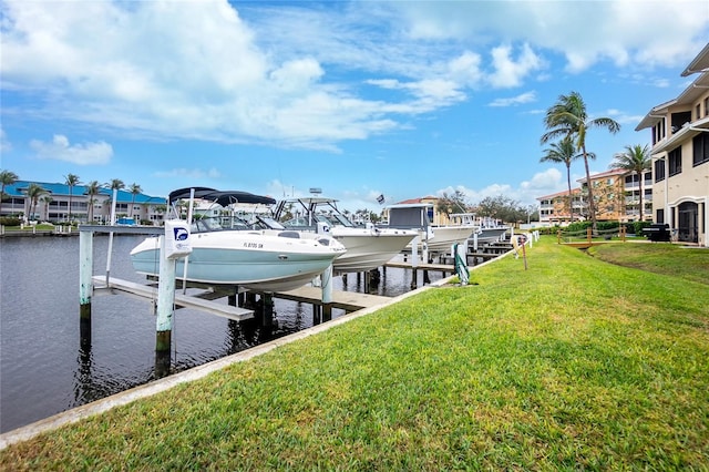 dock area with a lawn and a water view