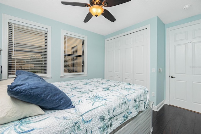 bedroom with dark wood-type flooring, a closet, and ceiling fan