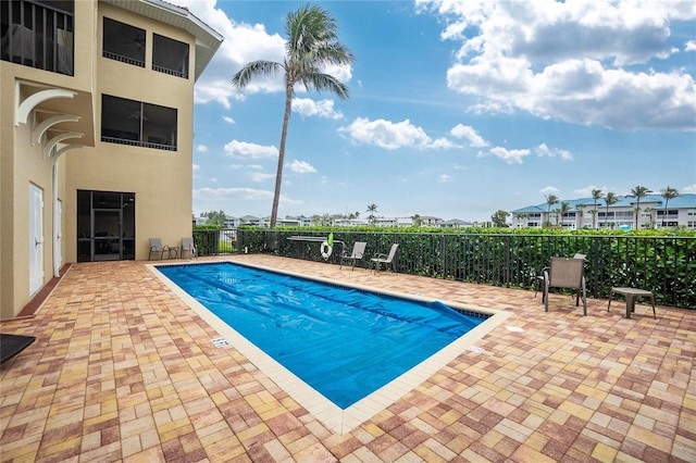 view of swimming pool with a patio