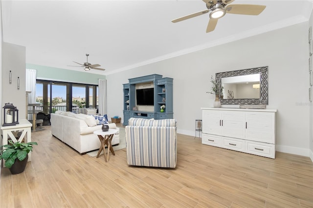 living room with ornamental molding, ceiling fan, and light wood-type flooring