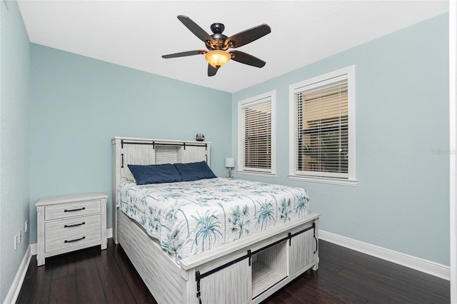 bedroom with dark hardwood / wood-style floors and ceiling fan