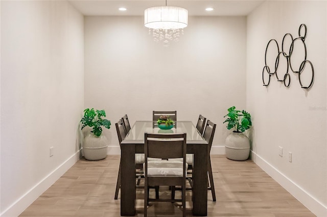 dining space featuring a chandelier and light hardwood / wood-style flooring