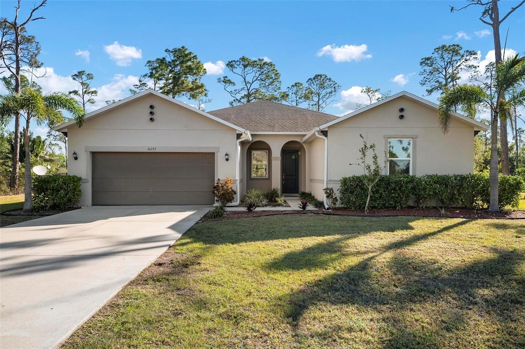 ranch-style house featuring a front yard and a garage