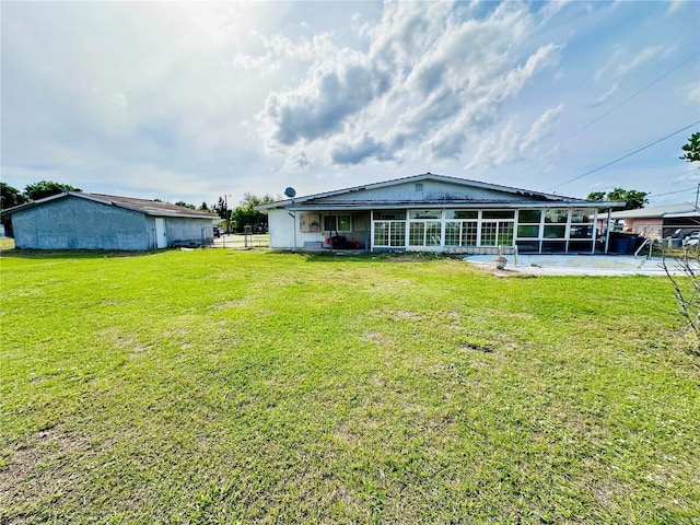 rear view of property with a lawn