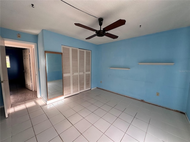 empty room featuring ceiling fan and light tile patterned floors