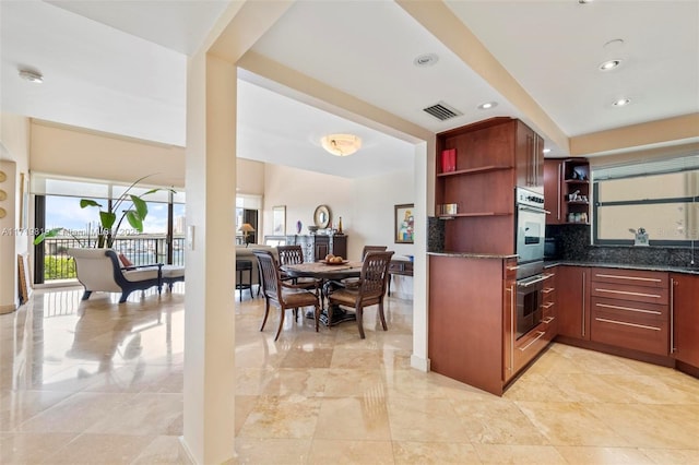 kitchen featuring decorative backsplash and stainless steel double oven