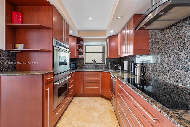 kitchen featuring black appliances, dark stone countertops, tasteful backsplash, and exhaust hood