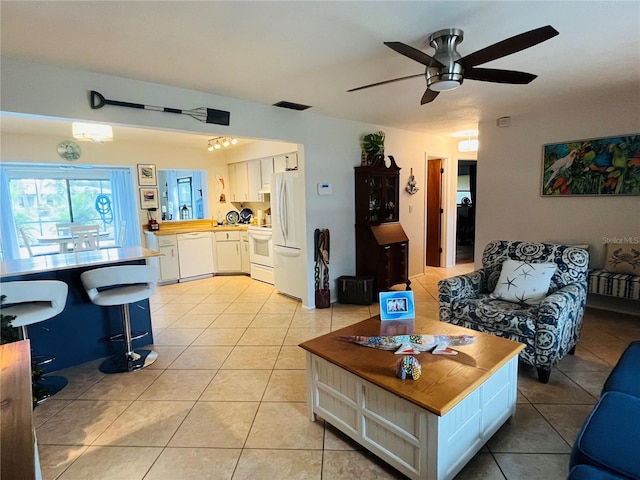 living room with ceiling fan and light tile patterned floors