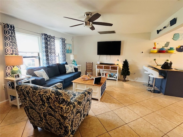 living room with ceiling fan and light tile patterned floors