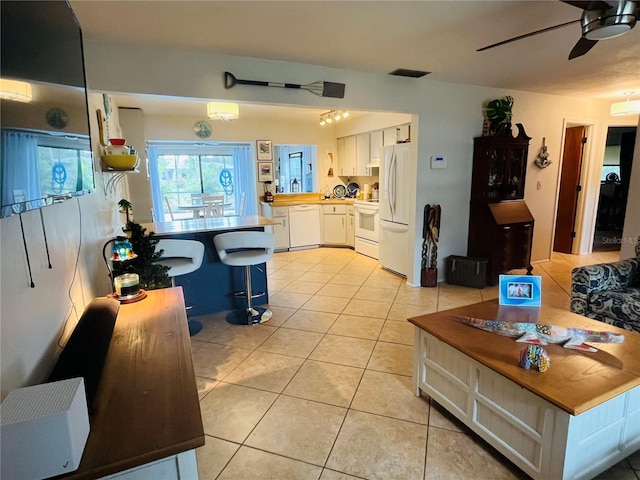 living room with ceiling fan and light tile patterned floors