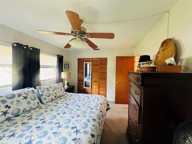 carpeted bedroom featuring ceiling fan and a closet