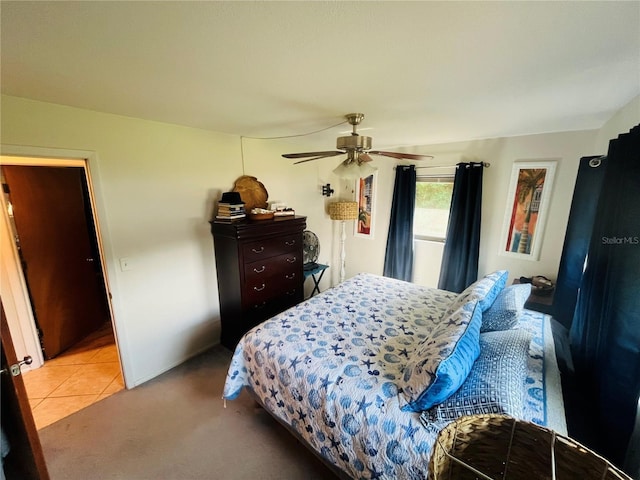 bedroom with ceiling fan and light tile patterned floors