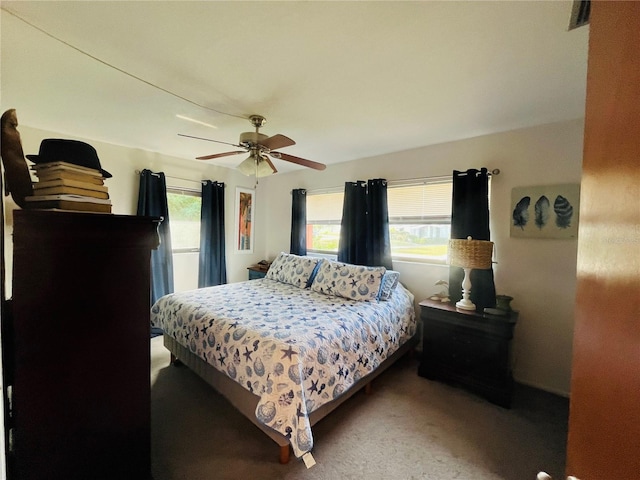 bedroom featuring ceiling fan and carpet