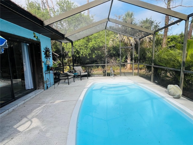 view of swimming pool featuring a lanai and a patio