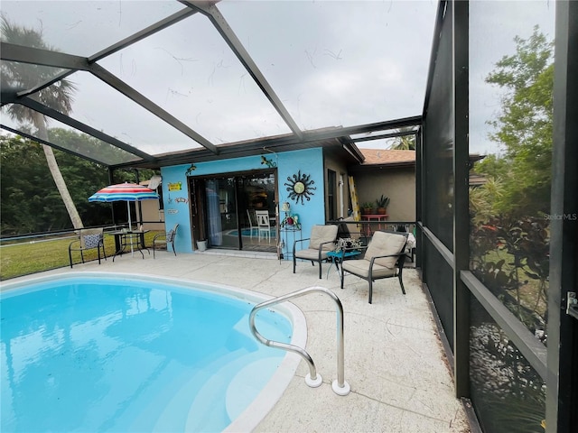 view of pool featuring a lanai and a patio