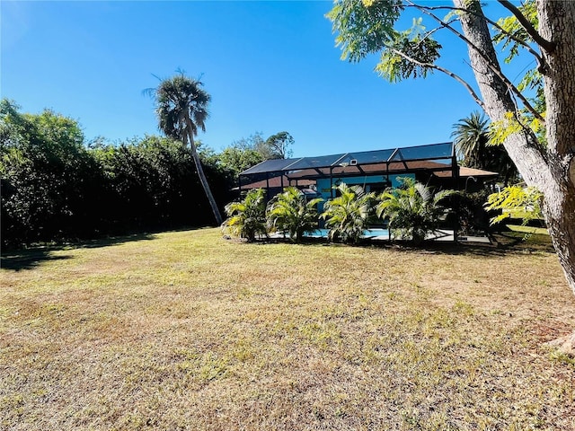 view of yard featuring glass enclosure