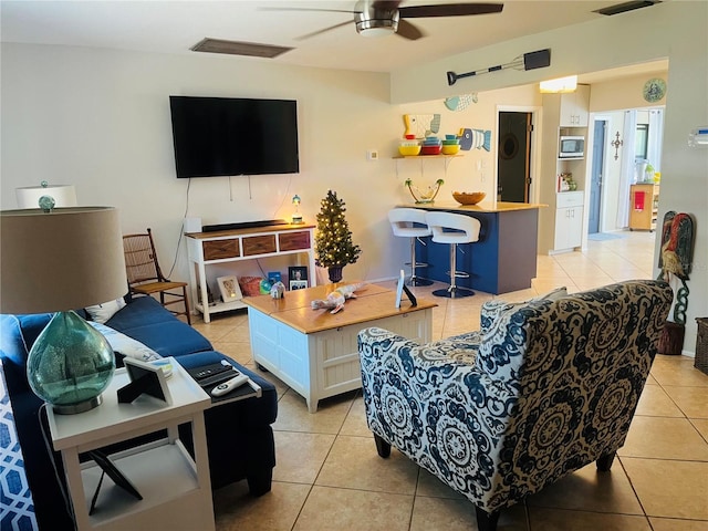 tiled living room featuring ceiling fan