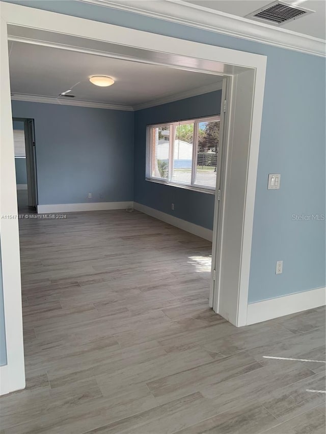 empty room featuring ornamental molding