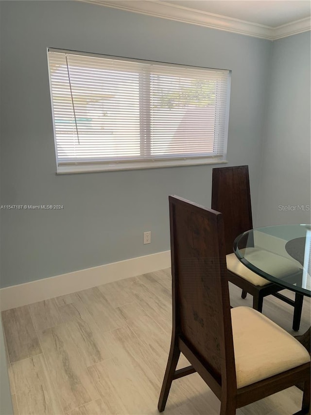 dining space with crown molding