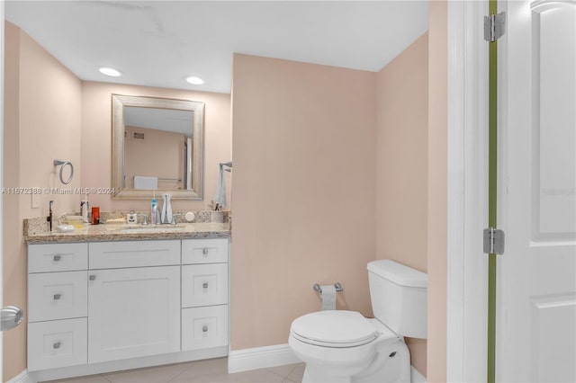 bathroom featuring tile patterned floors, vanity, and toilet