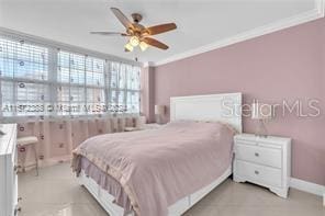 bedroom featuring ceiling fan and ornamental molding