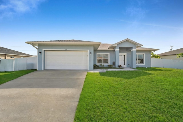 view of front of house featuring a front yard and a garage