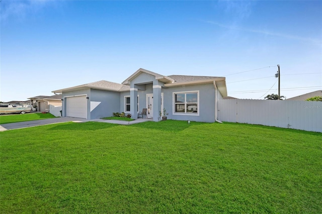 view of front of property with a front yard and a garage