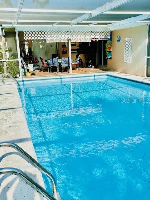 view of pool featuring a lanai and a patio