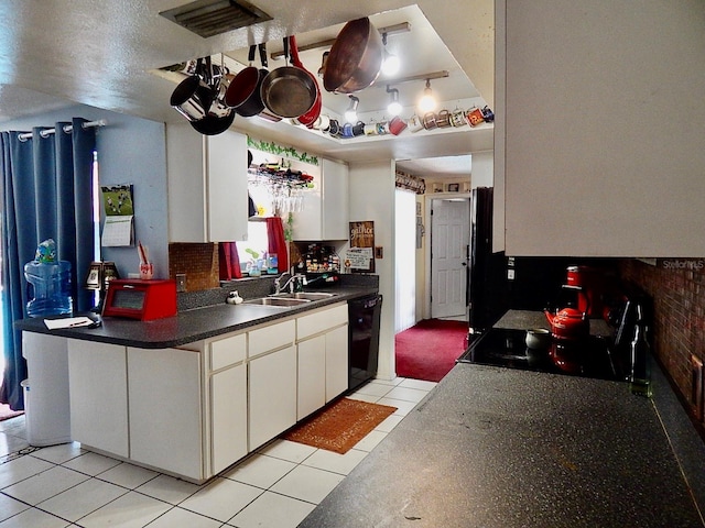 kitchen with black appliances, visible vents, white cabinetry, and a sink