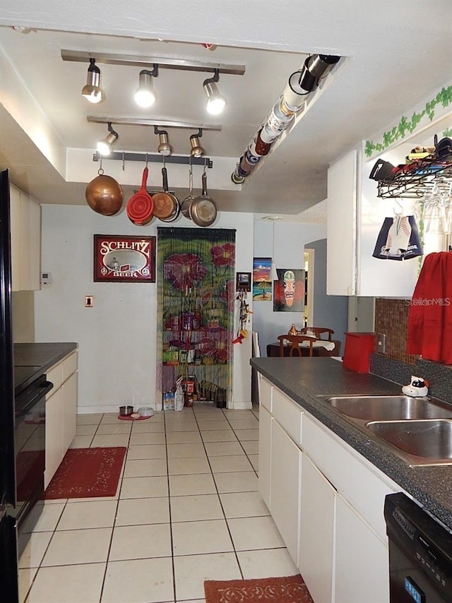 kitchen featuring a sink, dark countertops, and dishwasher