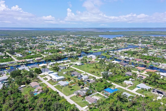 drone / aerial view featuring a water view and a residential view