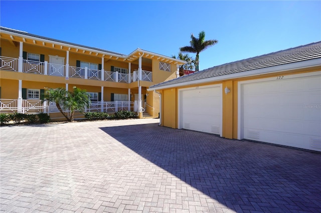 exterior space featuring a balcony and a garage