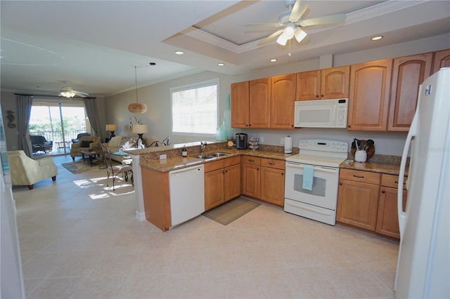 kitchen featuring hanging light fixtures, a raised ceiling, kitchen peninsula, white appliances, and ornamental molding