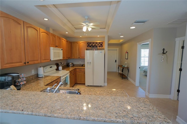 kitchen featuring white appliances, a tray ceiling, ceiling fan, and sink